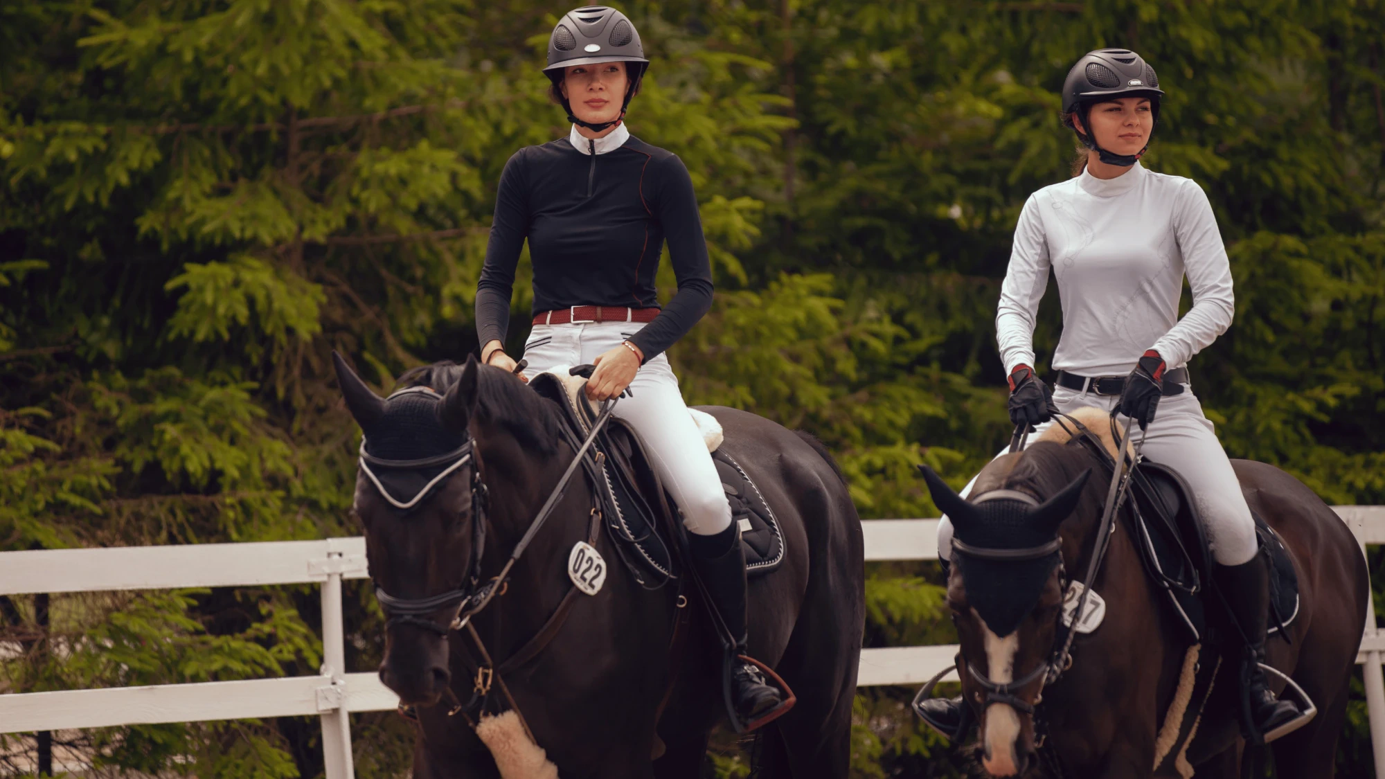 Two riders on horseback at golden hour